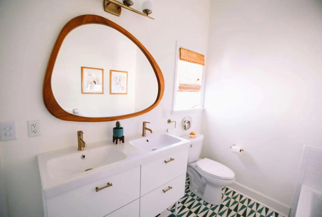 Newly renovated white bathroom with wooden accents. Keen Bathrooms - bathroom renovations St Catharines trusts.